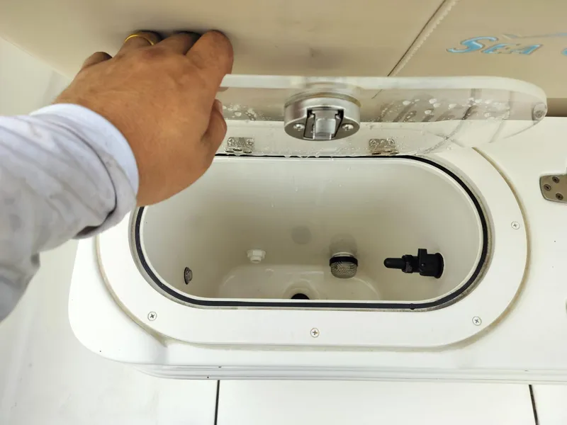 Slide: The Image of Hand opening livewell on 2017 Sea Chaser 24 HFC boat. - 48