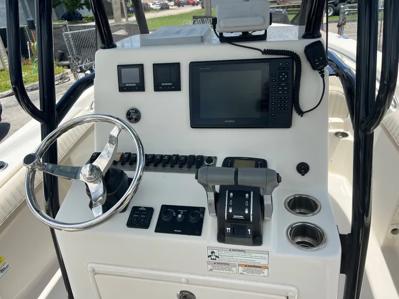 Slide: The Image of 2017 Sea Chaser 24 HFC boat console with steering wheel, controls, and navigation system. - 5