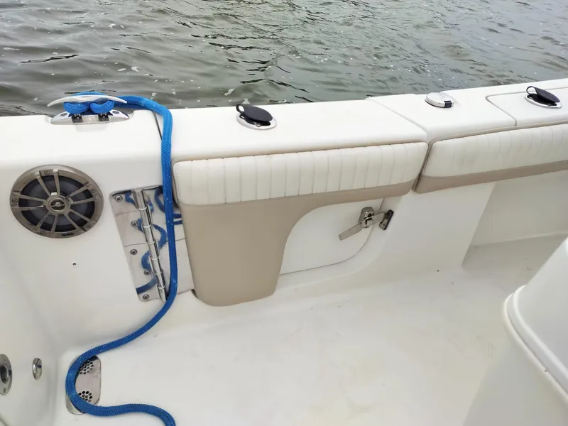 Slide: The Image of 2017 Sea Chaser 24 HFC boat interior with seating and blue rope by the water. - 6