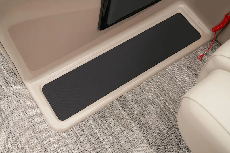 Slide: The Image of 2024 Ranger Reata 220FC interior step with non-slip mat and carpeted flooring. - 27