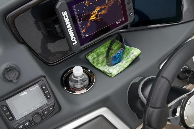 Slide: The Image of Dashboard of 2024 Ranger Reata 220FC with Lowrance fishfinder, water bottle, and sunglasses. - 34