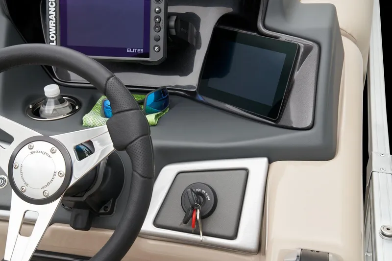 Slide: The Image of 2024 Ranger Reata 220FC boat dashboard with steering wheel, ignition, and electronic displays. - 39
