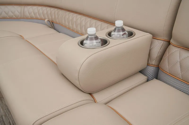 Slide: The Image of 2024 Ranger Reata 220FC beige leather seating with built-in cup holders. - 48