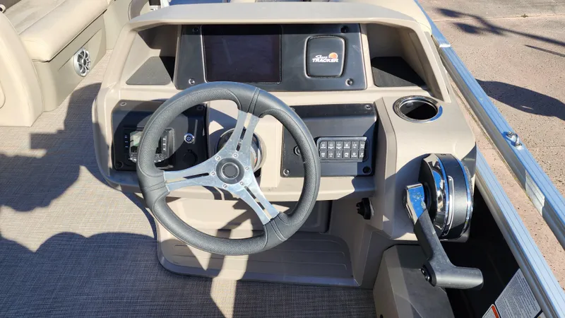 Slide: The Image of 2024 Sun Tracker SportFish 22 DLX boat dashboard with steering wheel and control panel. - 4
