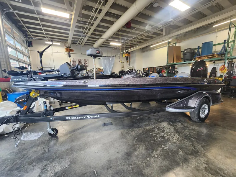 The Image of 2024 Ranger Z519 boat in a garage on a Ranger Trail trailer. - 0