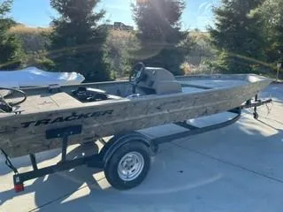 The Image of 2024 Tracker Grizzly 1754 SC boat on trailer, parked outdoors in sunlight. - 0