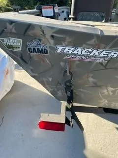Slide: The Image of 2024 Tracker Grizzly 1754 SC boat with camo design and decals. - 2