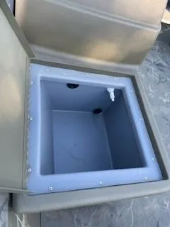 Slide: The Image of 2024 Tracker Grizzly 1754 SC boat storage compartment, open lid, interior view. - 3