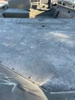 Slide: The Image of 2024 Tracker Grizzly 1754 SC boat interior with camo pattern and seating. - 5