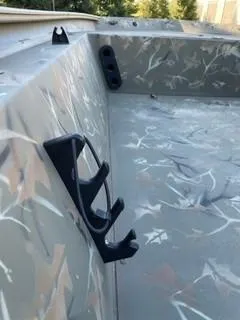 Slide: The Image of 2024 Tracker Grizzly 1754 SC boat interior with camouflage design and rod holders. - 7