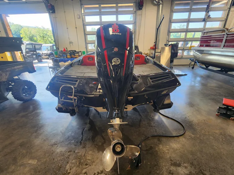 Slide: The Image of 2024 Ranger Z518 boat in a garage, rear view with outboard motor. - 3