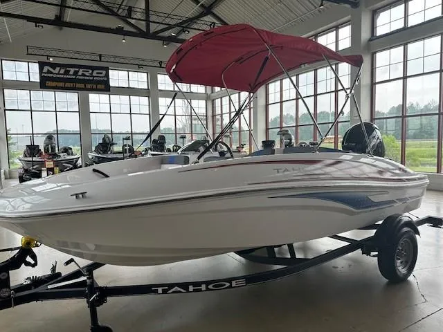 Slide: The Image of 2024 Tahoe T16 boat with red canopy on display in showroom. - 0