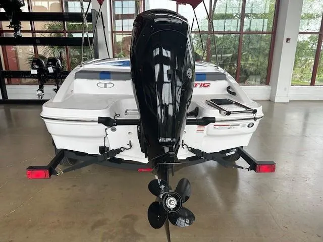 Slide: The Image of 2024 Tahoe T16 boat rear view with outboard motor in showroom. - 2