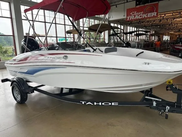 Slide: The Image of 2024 Tahoe T16 boat on trailer in showroom with red canopy. - 4