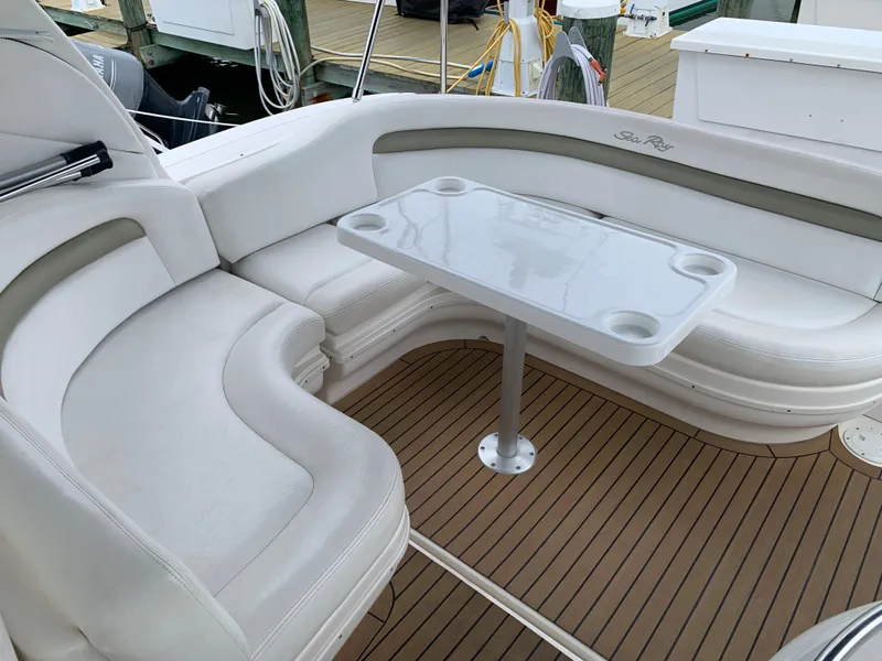 Slide: The Image of 2006 Sea Ray 340 Sundancer boat interior with white seating and table. - 14