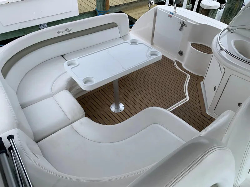Slide: The Image of 2006 Sea Ray 340 Sundancer cockpit with white seating and table. - 15