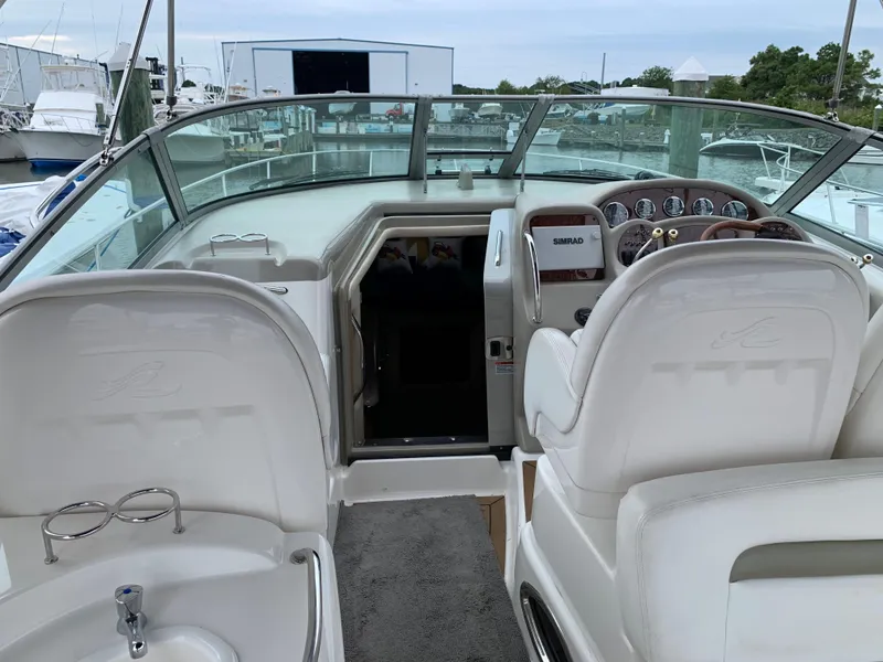 Slide: The Image of 2006 Sea Ray 340 Sundancer cockpit with helm and seating area. - 17