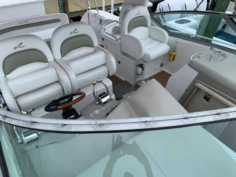 Slide: The Image of 2006 Sea Ray 340 Sundancer cockpit with dual helm seats and steering wheel. - 18