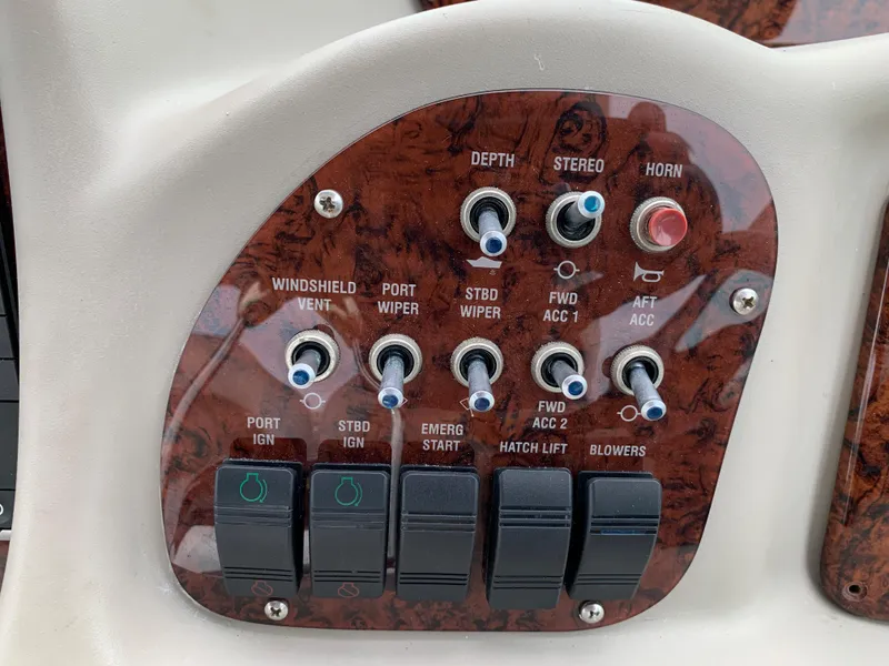 Slide: The Image of Control panel of a 2006 Sea Ray 340 Sundancer boat with various switches and buttons. - 24