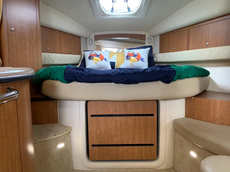 Slide: The Image of 2006 Sea Ray 340 Sundancer cabin interior with bed and storage. - 32