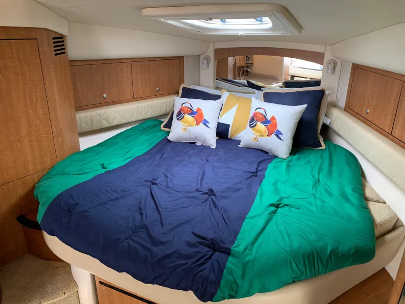Slide: The Image of Interior cabin of 2006 Sea Ray 340 Sundancer with cozy bed and colorful pillows. - 33