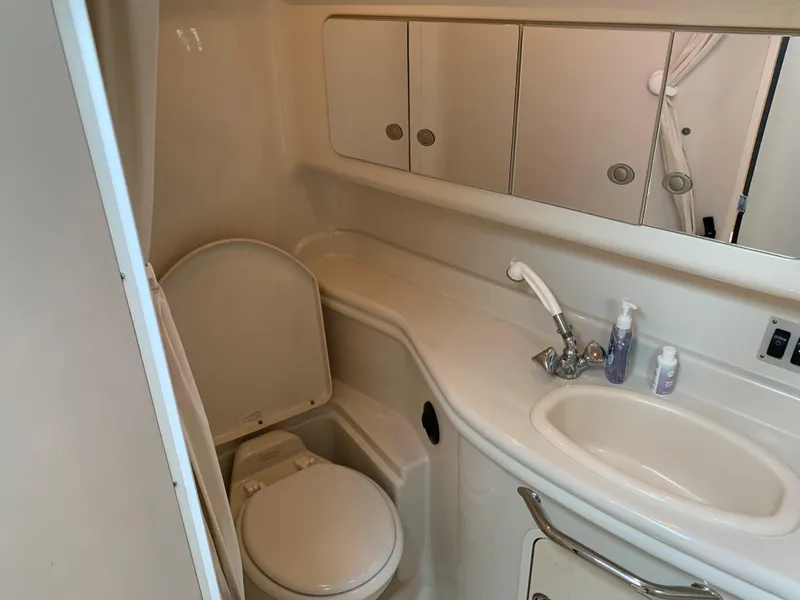 Slide: The Image of 2006 Sea Ray 340 Sundancer bathroom with sink, toilet, and mirrored cabinets. - 39