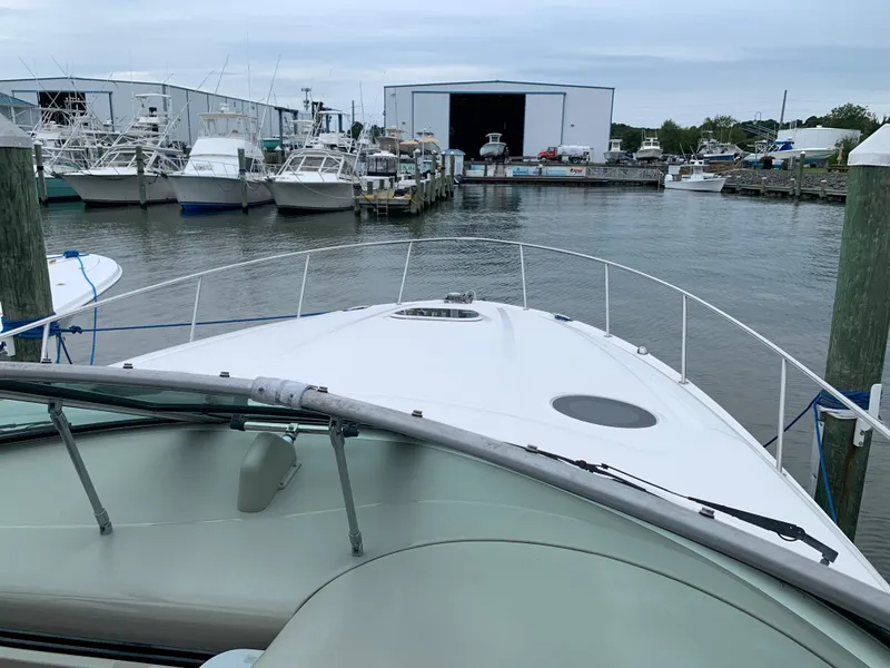 Slide: The Image of 2006 Sea Ray 340 Sundancer docked at a marina with other boats. - 8