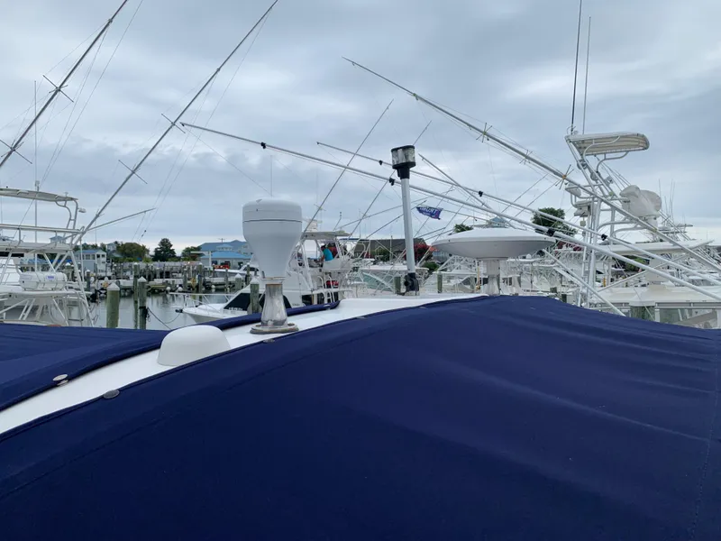 Slide: The Image of 2006 Sea Ray 340 Sundancer docked at a marina under a cloudy sky. - 9