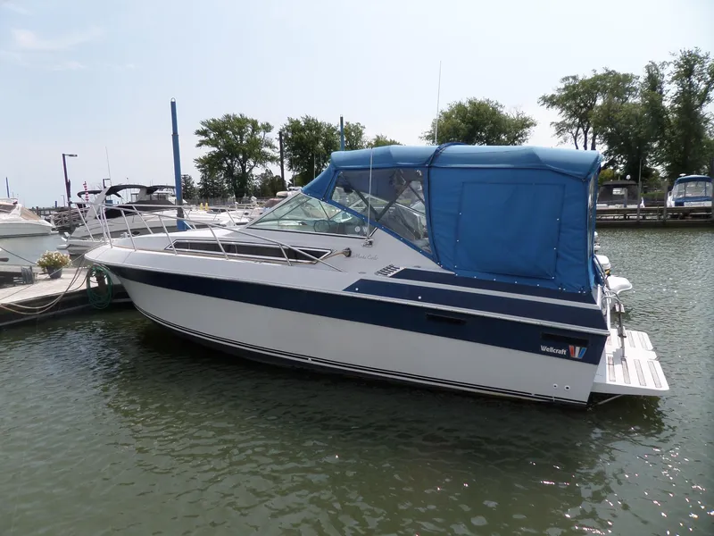 Slide: The Image of 1986 Wellcraft Monte Carlo 2800 boat docked in a marina. - 1