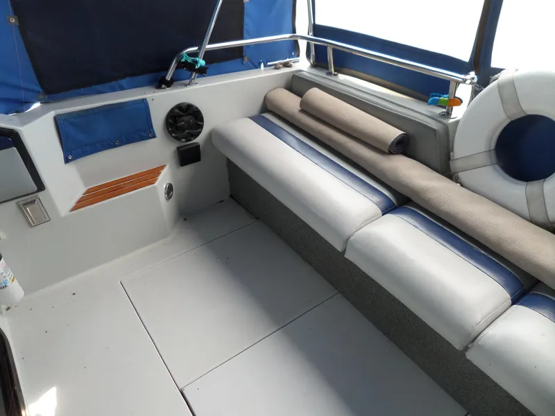Slide: The Image of Interior seating area of 1986 Wellcraft Monte Carlo 2800 boat with blue and white upholstery. - 10