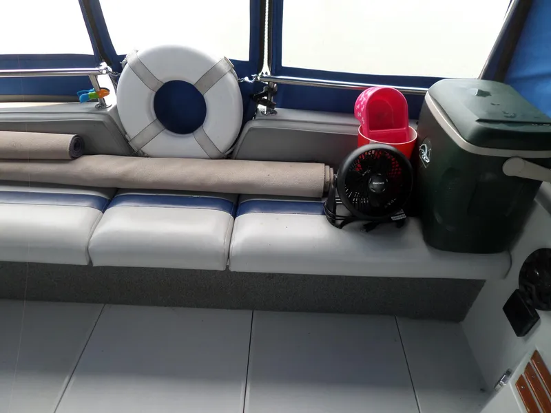 Slide: The Image of Interior of 1986 Wellcraft Monte Carlo 2800 with life preserver, fan, and cooler. - 11