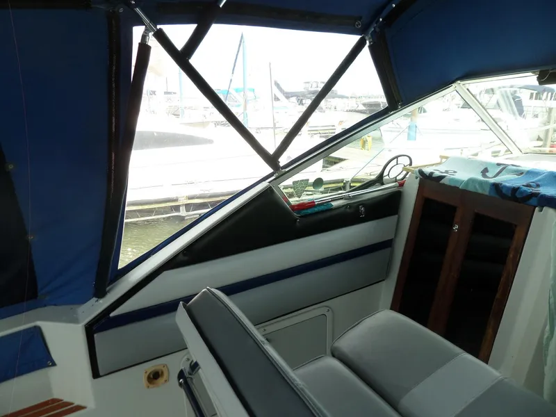 Slide: The Image of Interior of 1986 Wellcraft Monte Carlo 2800 boat with marina view. - 13
