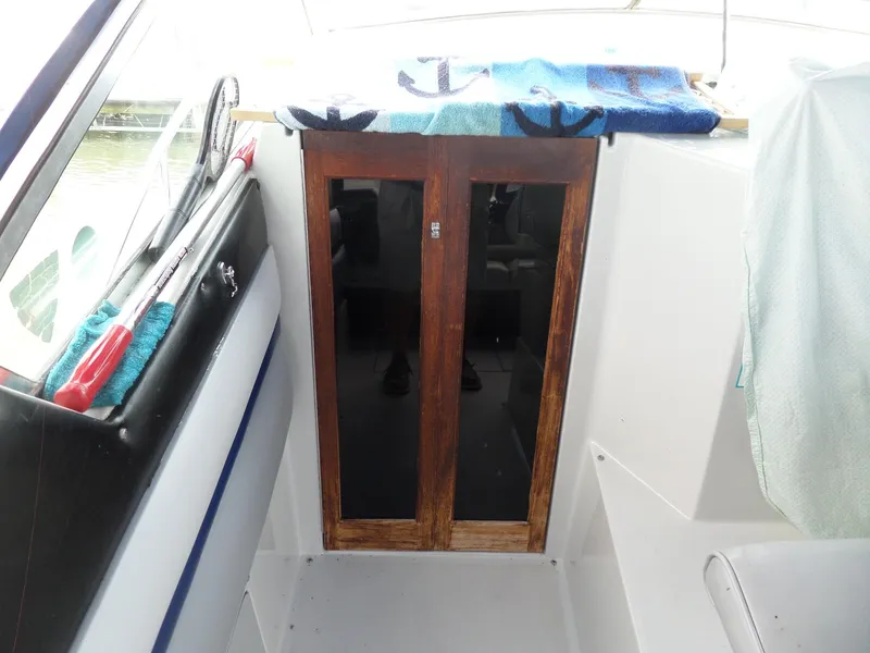 Slide: The Image of 1986 Wellcraft Monte Carlo 2800 boat interior with wooden cabinet doors. - 15