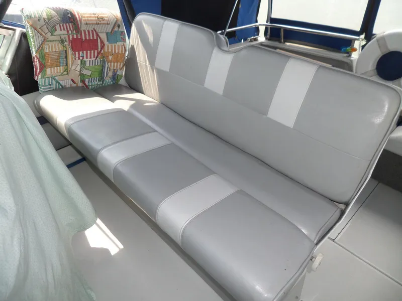 Slide: The Image of 1986 Wellcraft Monte Carlo 2800 boat interior with gray and white seating. - 16
