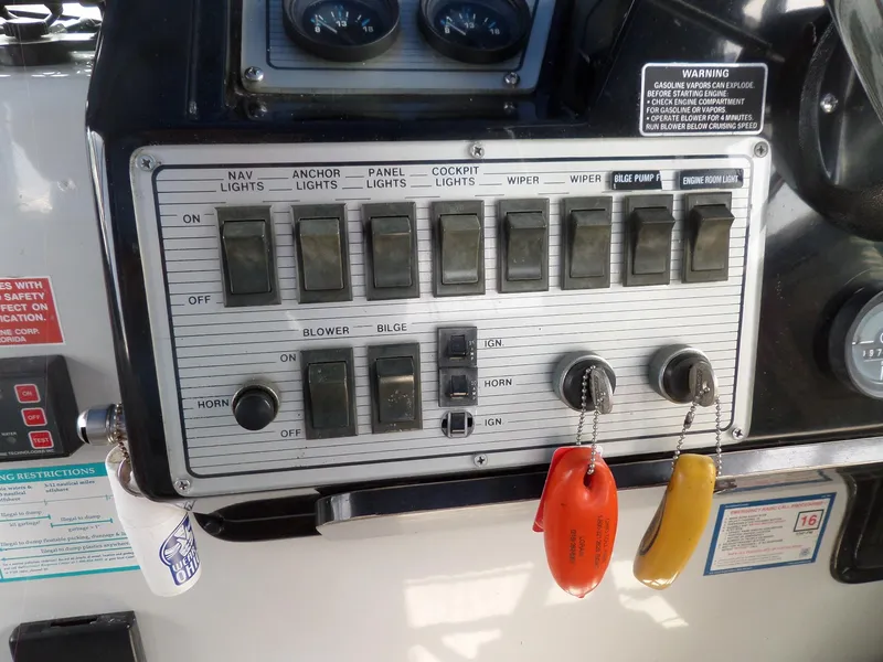 Slide: The Image of Control panel of a 1986 Wellcraft Monte Carlo 2800 boat with labeled switches and keys. - 19