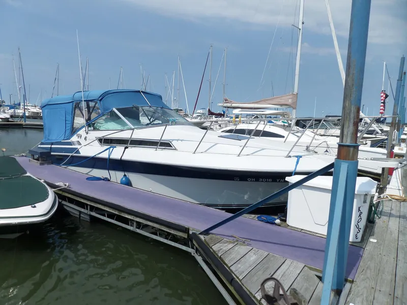 Slide: The Image of 1986 Wellcraft Monte Carlo 2800 docked at a marina. - 2