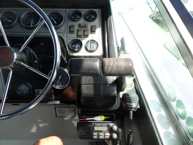 Slide: The Image of 1986 Wellcraft Monte Carlo 2800 boat dashboard with steering wheel and control panel. - 25
