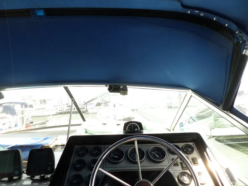 Slide: The Image of 1986 Wellcraft Monte Carlo 2800 boat helm with steering wheel and instrument panel. - 26