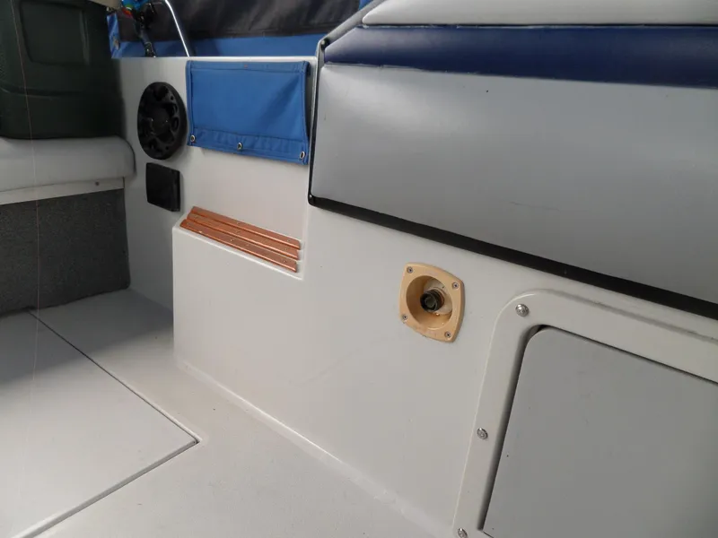 Slide: The Image of Interior of a 1986 Wellcraft Monte Carlo 2800 boat showing seating and storage compartments. - 28