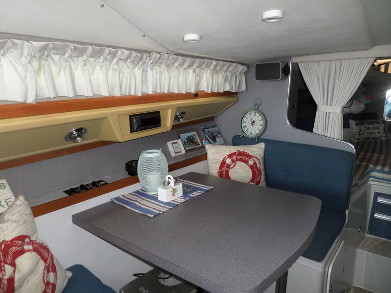 Slide: The Image of Interior of 1986 Wellcraft Monte Carlo 2800 boat with dining area and nautical decor. - 29