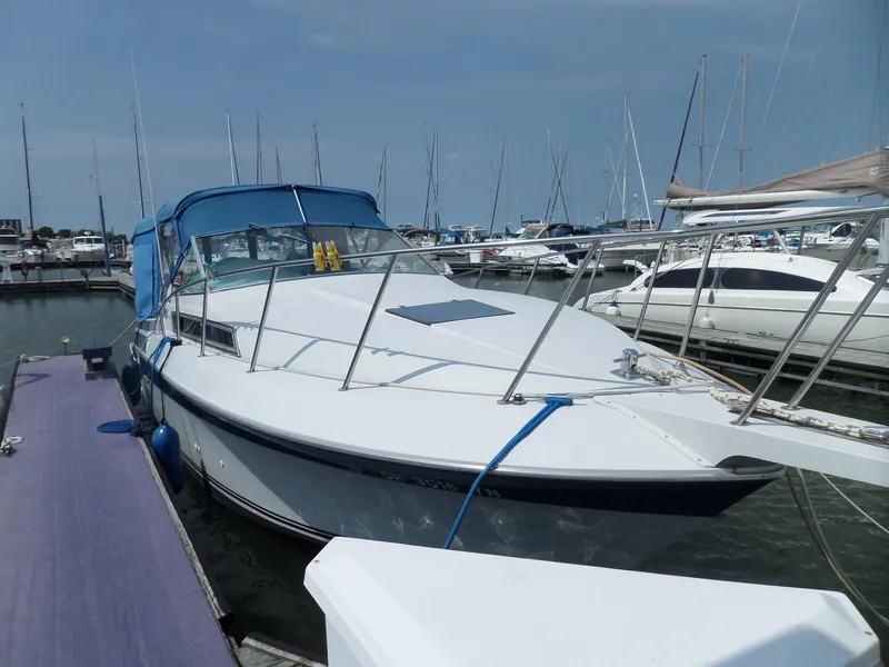 Slide: The Image of 1986 Wellcraft Monte Carlo 2800 docked at a marina. - 3