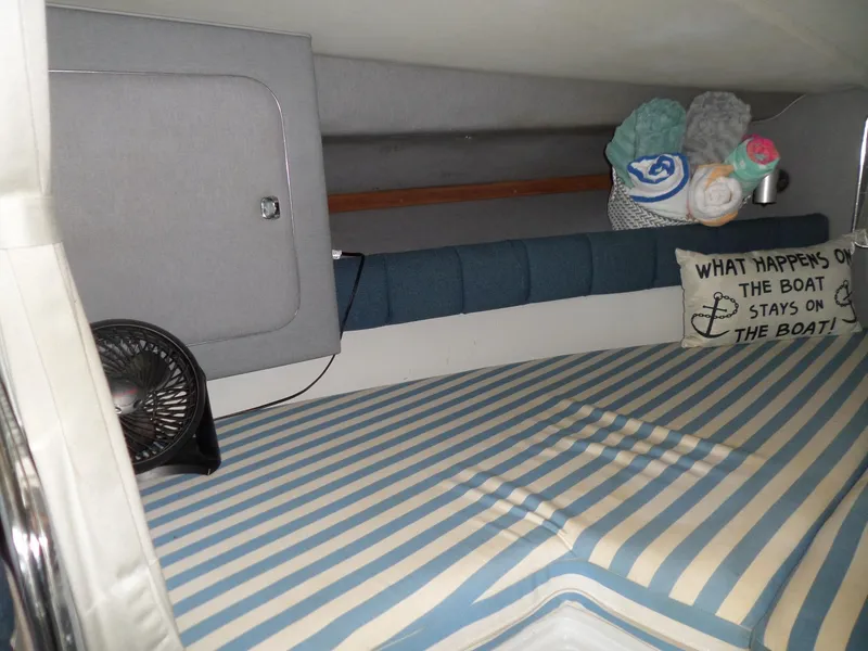 Slide: The Image of Interior cabin of 1986 Wellcraft Monte Carlo 2800 with striped bedding and decorative pillow. - 33