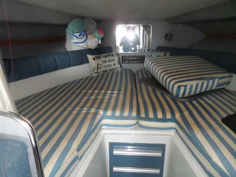Slide: The Image of Interior cabin of a 1986 Wellcraft Monte Carlo 2800 boat with striped cushions. - 34