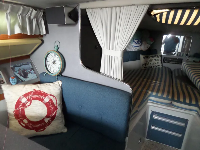 Slide: The Image of Interior of 1986 Wellcraft Monte Carlo 2800 boat with nautical decor and striped bedding. - 37