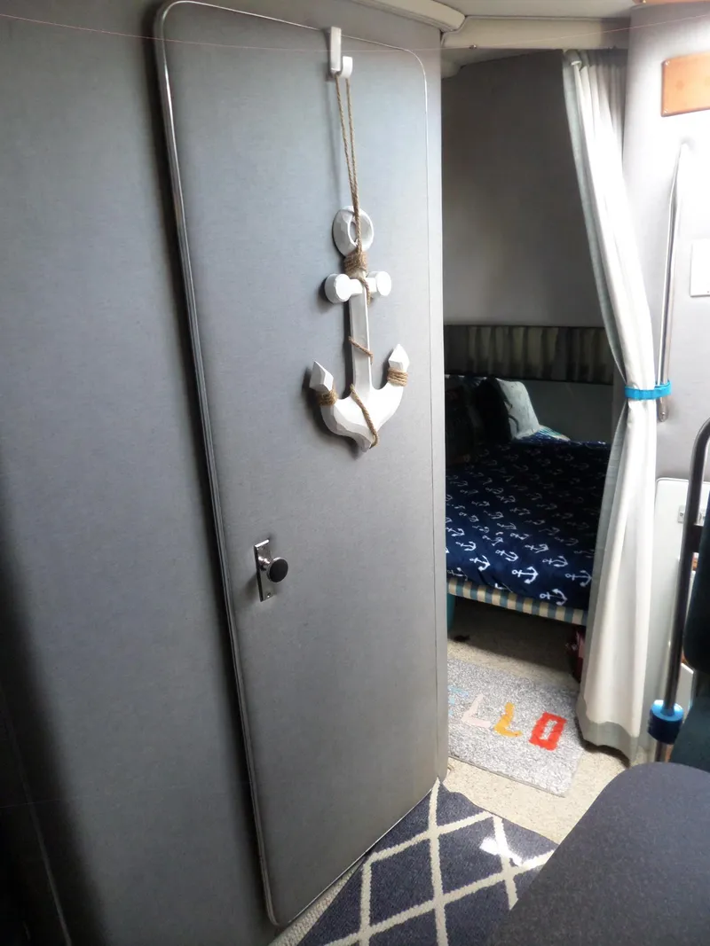 Slide: The Image of Interior of a 1986 Wellcraft Monte Carlo 2800 boat with nautical decor. - 43