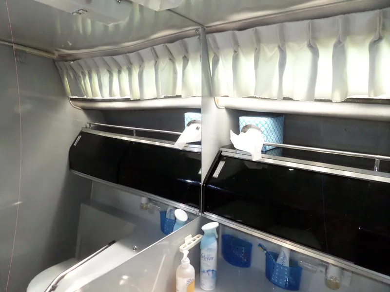 Slide: The Image of 1986 Wellcraft Monte Carlo 2800 bathroom with mirror, sink, and storage shelves. - 47