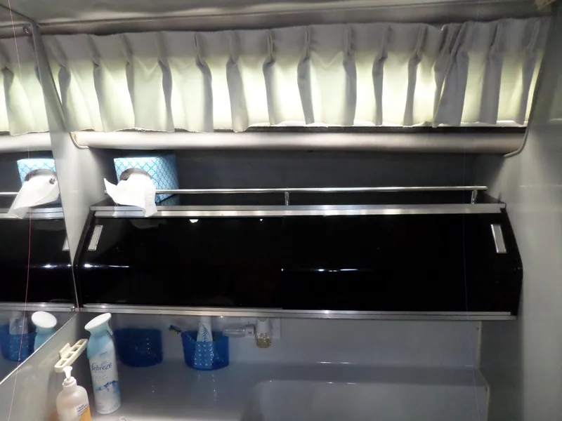 Slide: The Image of 1986 Wellcraft Monte Carlo 2800 bathroom with storage cabinet and toiletries. - 48