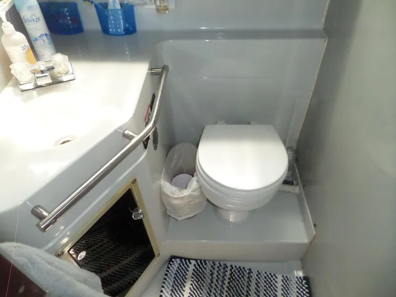 Slide: The Image of Compact bathroom in 1986 Wellcraft Monte Carlo 2800 boat with sink and toilet. - 49