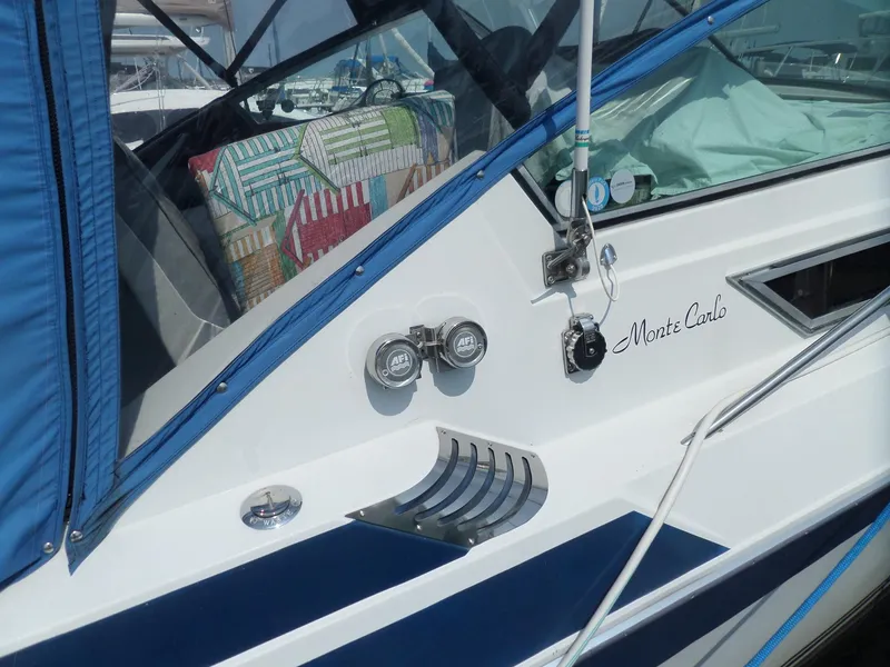 Slide: The Image of 1986 Wellcraft Monte Carlo 2800 boat with blue canopy and colorful interior. - 5