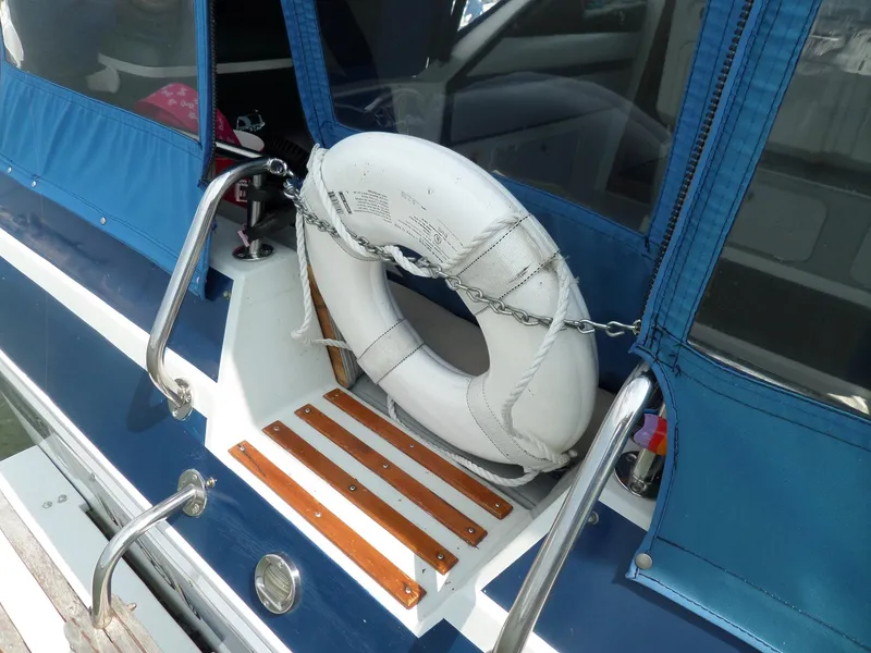 Slide: The Image of 1986 Wellcraft Monte Carlo 2800 boat with life ring and blue canopy. - 6